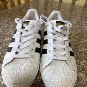 adidas White Sneakers with Black Stripes and Gold Tongue Accents